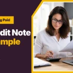 Credit note example, with a bookkeeper checking a printed invoice against a calculator
