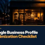 Google business profile optimization checklist cover showing a small coffee shop storefront lit up at dusk on a wet street.